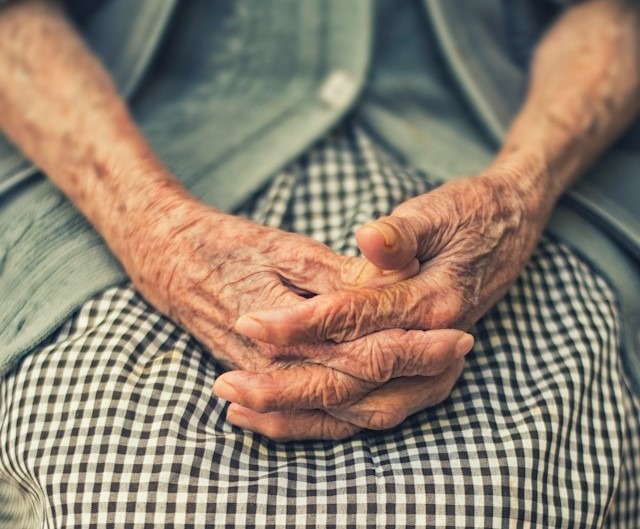 Folded hands of an old woman.